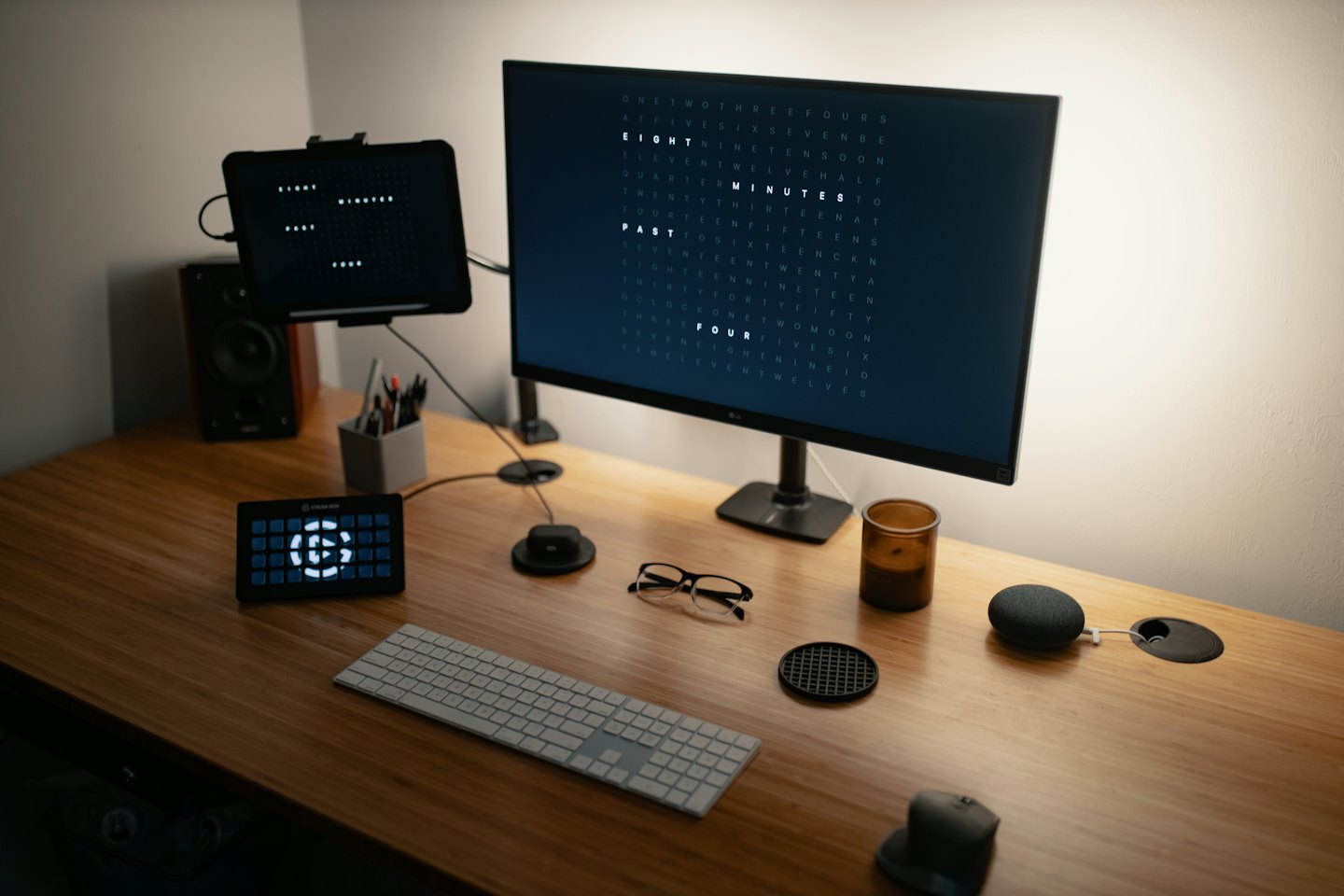 A modern home office desktop with a computer monitor and tablet.